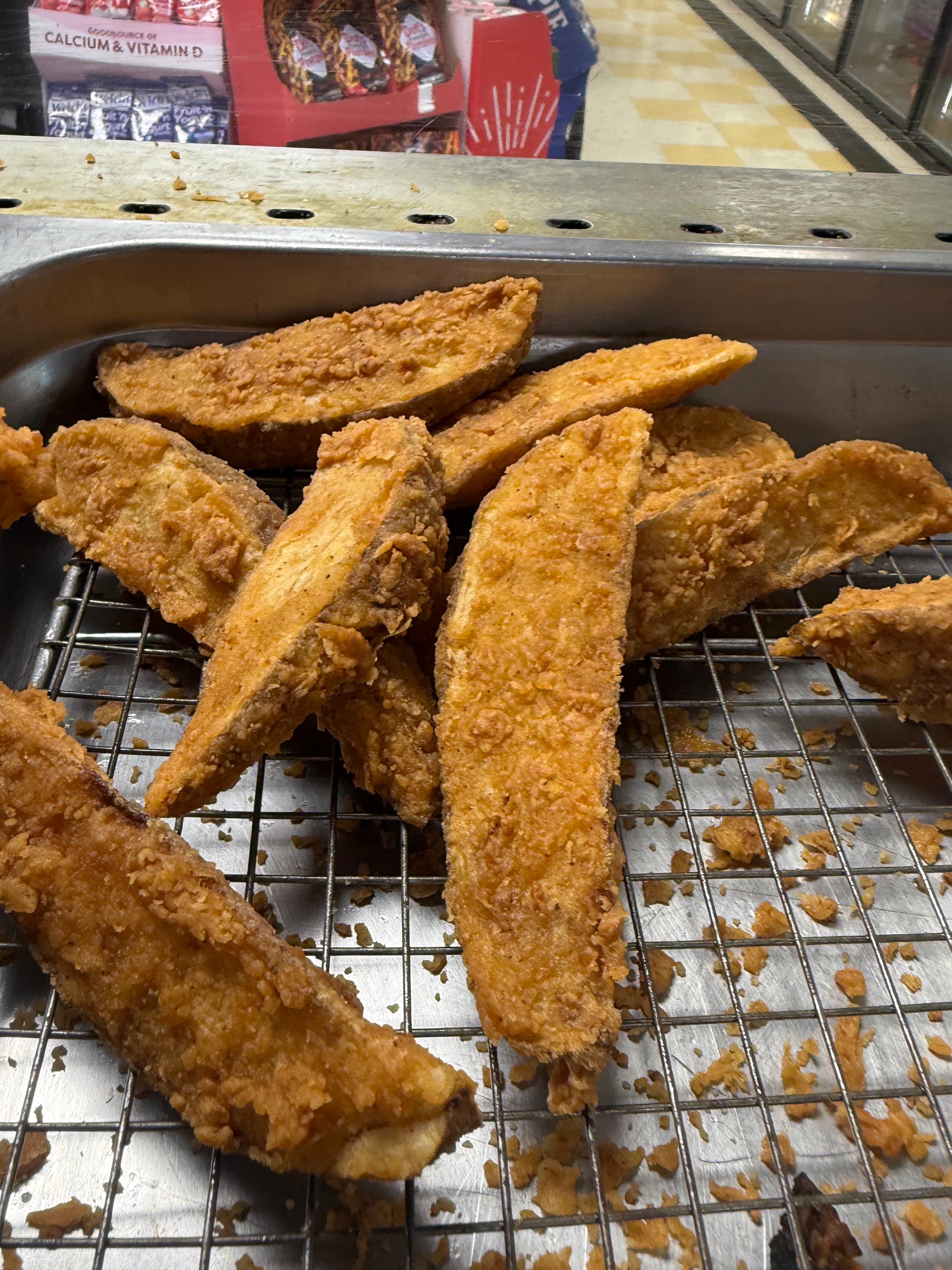 Seasoned potato wedges in the Big John's hot food case